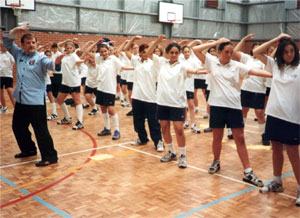 Allan teaching a Chi Kung class in a school
